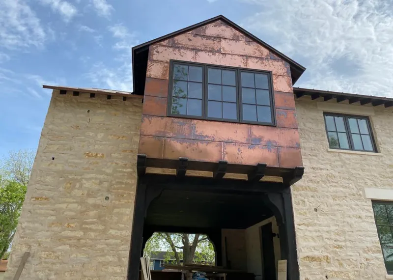 Copper metal panel facade on a stone building for Roof Repair in McFarland